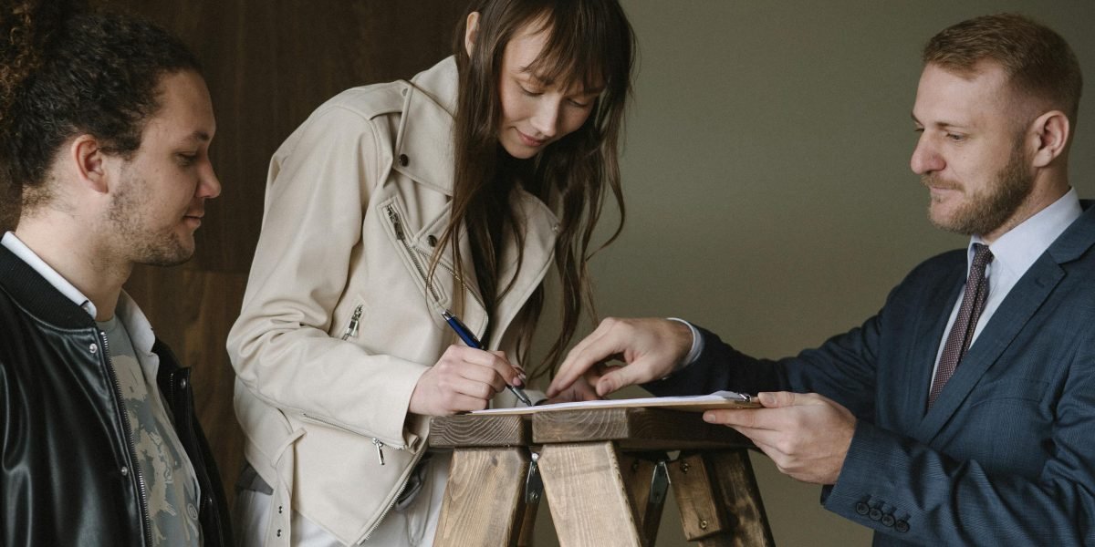A person confidently reviewing and signing documents, symbolizing a smooth and informed property transaction process.