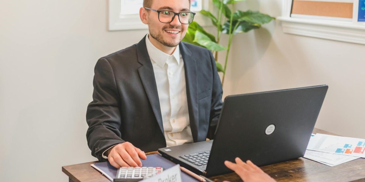 A real estate consultant providing expert advice and guidance to a client in a professional setting.