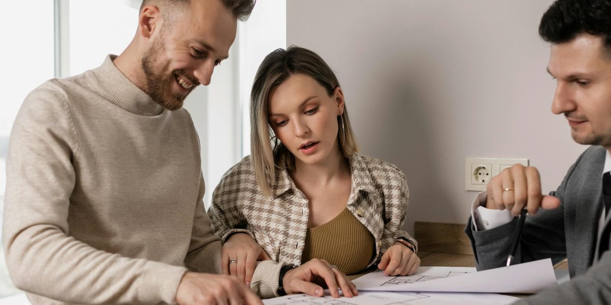 A couple reviewing property documents with a clear understanding, empowered by working with a knowledgeable, certified agent.