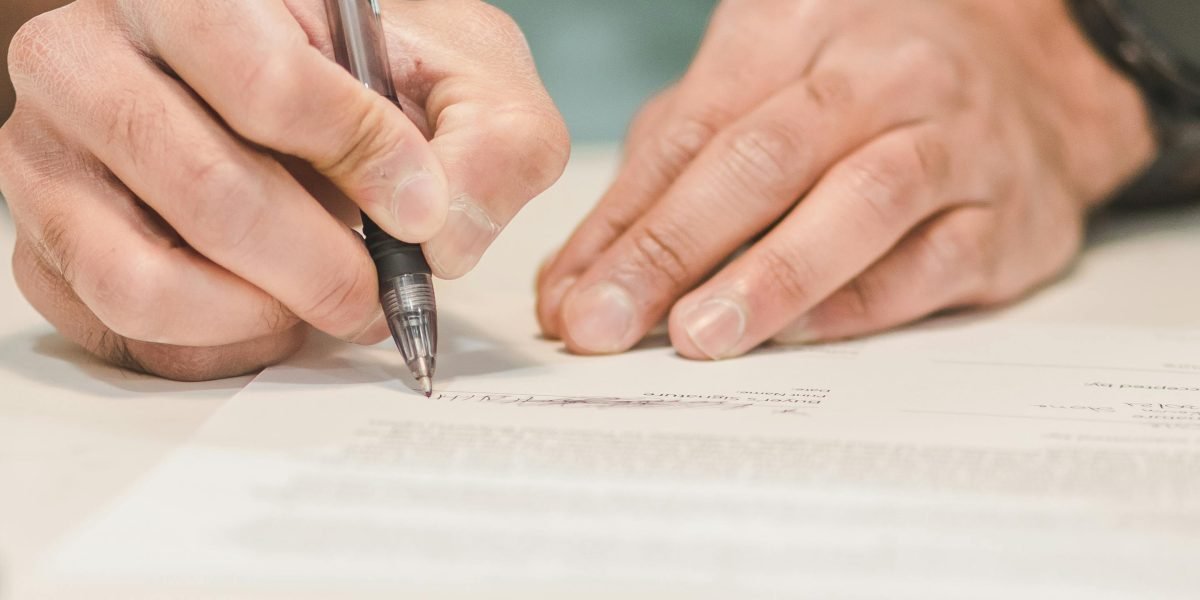 A person confidently making a significant investment decision in a professional setting.
