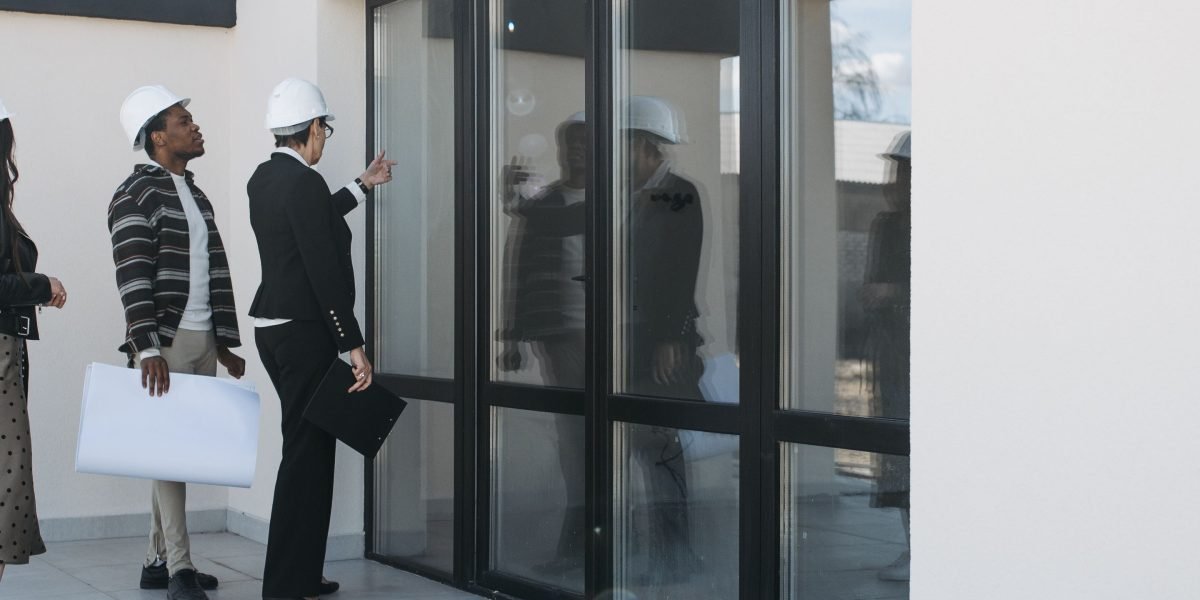 A team of professionals proudly examining the quality of a newly completed luxury building.