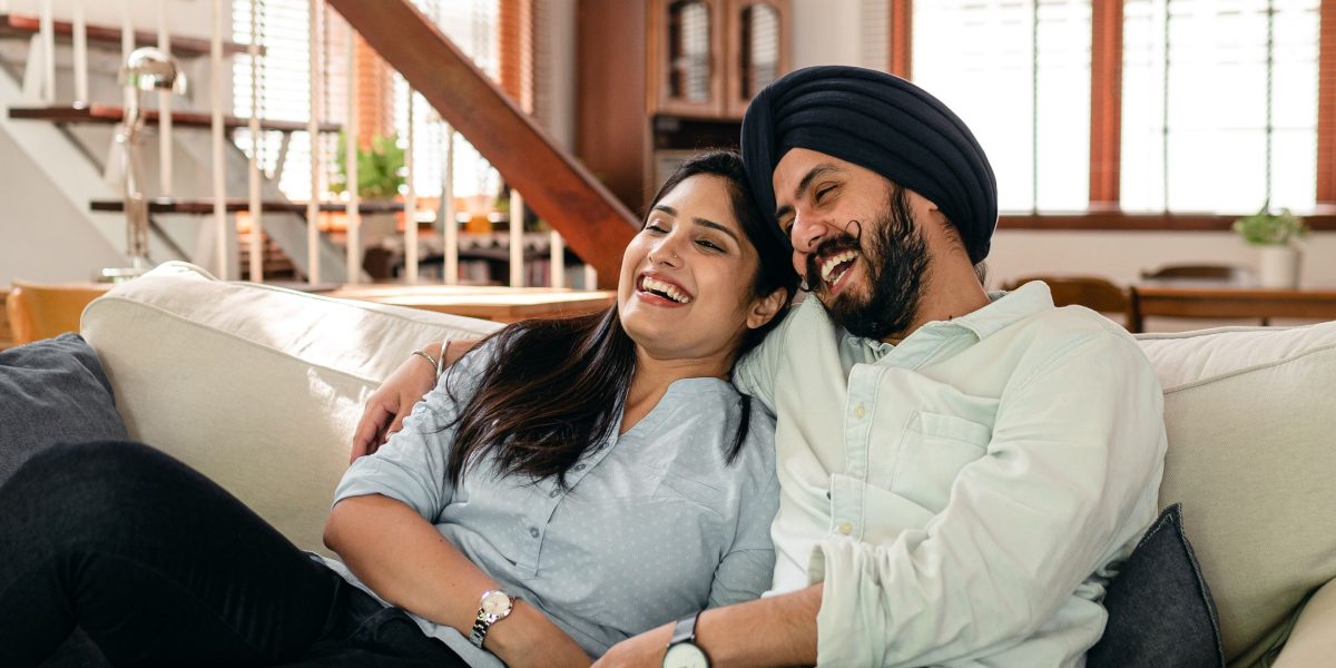 A happy couple enjoying the breathtaking view from their luxury home on Palm Jumeirah, symbolizing successful investment and lifestyle.