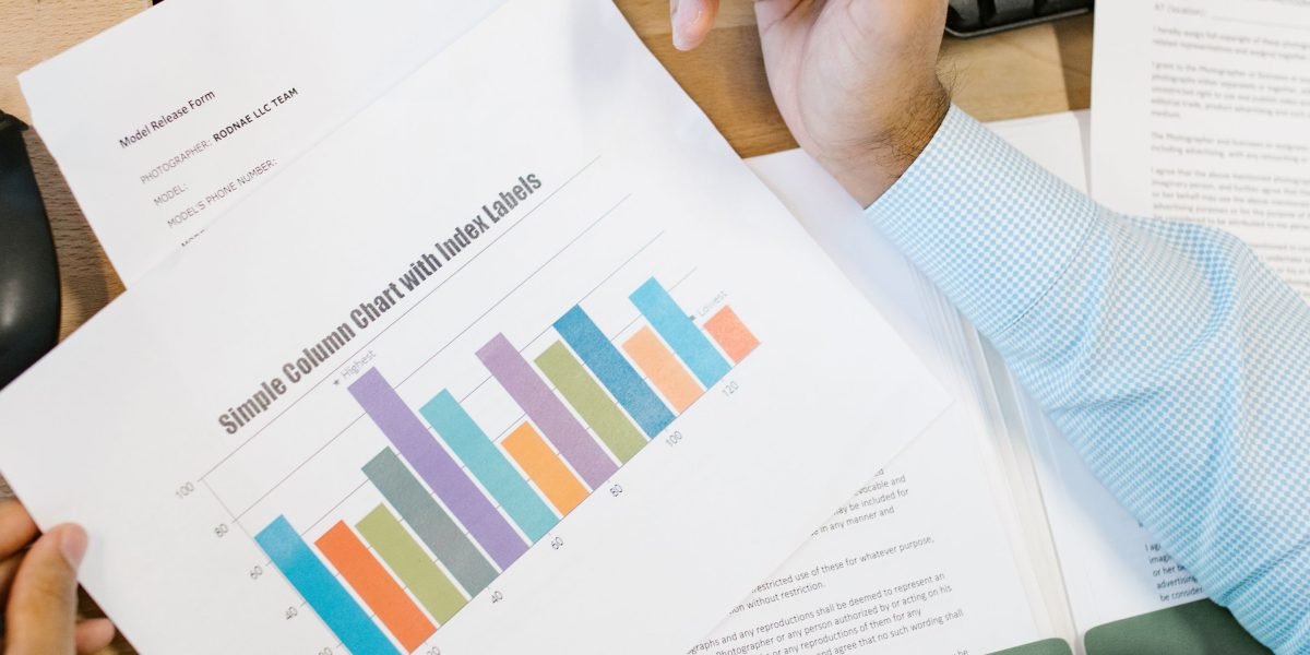 Real estate professionals collaborate to analyze market data and price trends for luxury properties.