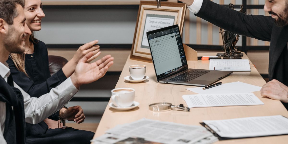 Two professionals discussing plans in a modern office, representing a high-value real estate consultation.