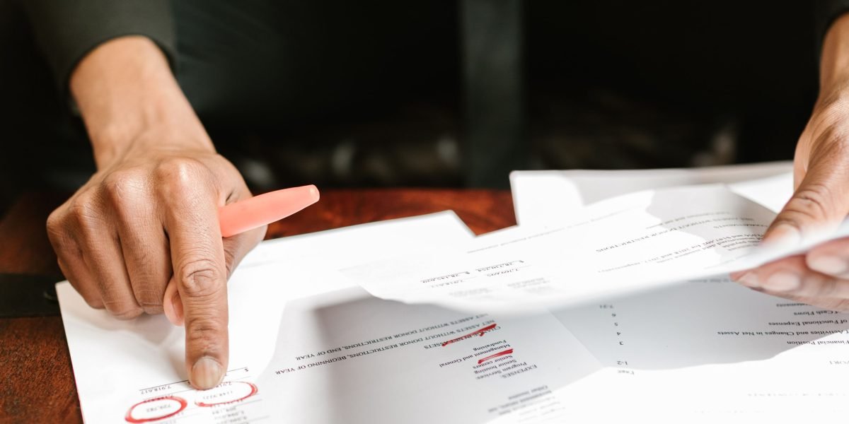 An investor meticulously reviews market data and valuation reports, essential for making informed property decisions.