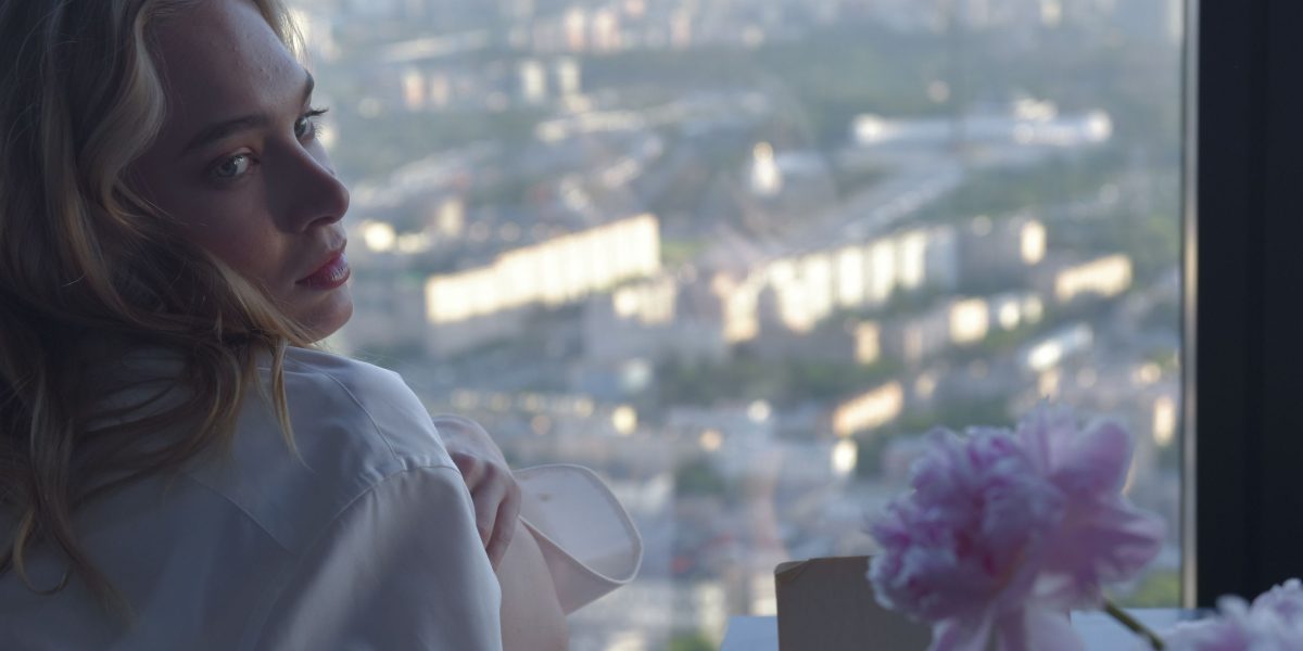 A person feeling overwhelmed while looking at a beautiful skyline, symbolizing the challenge of finding a dream home.