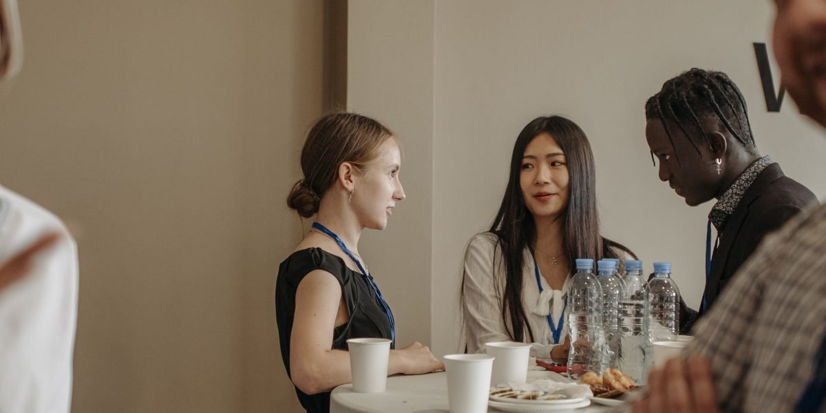 Individuals networking at a professional real estate event, ideal for meeting potential agents in person.