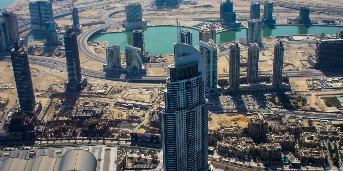 International investors convene in a modern setting with Dubai's iconic skyline visible, symbolizing the city's appeal as a global investment hub.