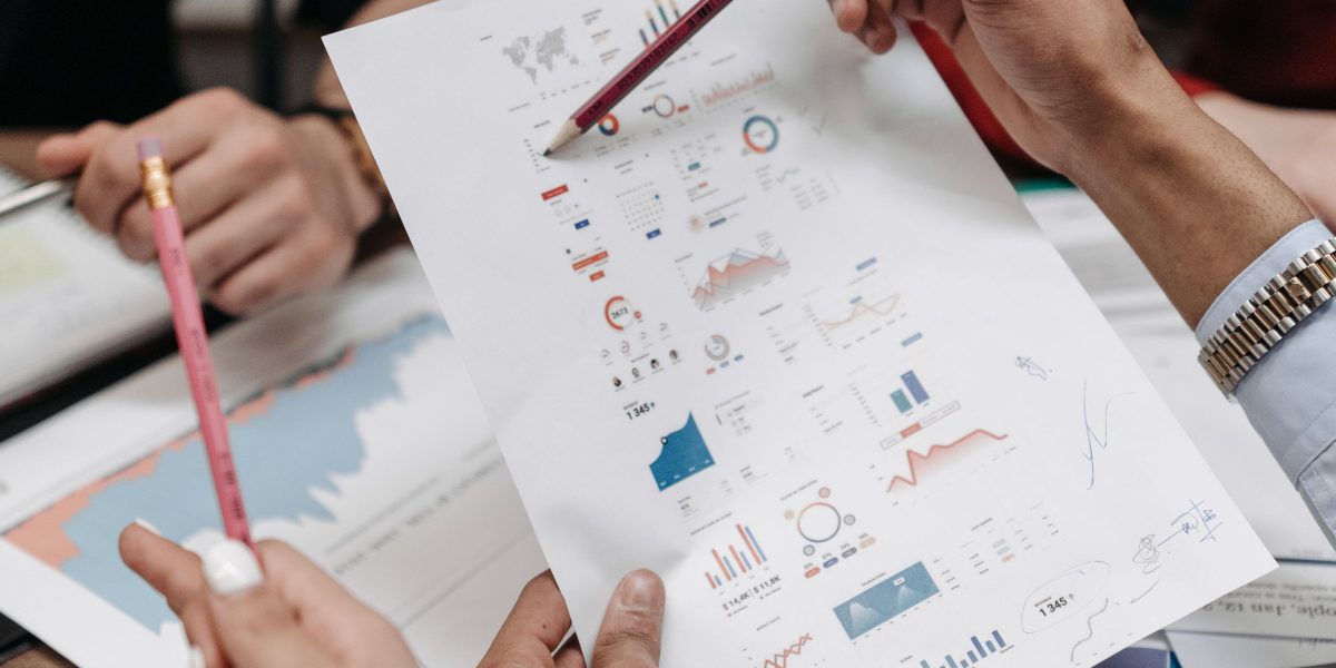 A group of professionals reviewing financial documents, symbolizing the thorough analysis of ROI and capital appreciation in real estate investment.