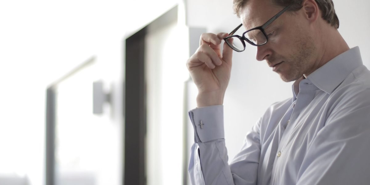 A person pondering significant financial decisions, like investing in real estate.