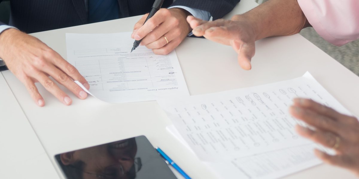 An expert real estate advisor clarifies complex contract details for a client, ensuring a smooth luxury property transaction.