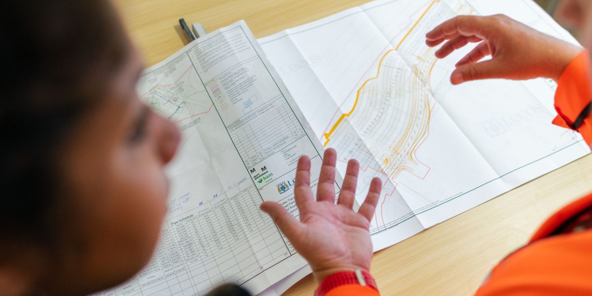 Professionals reviewing plans and discussing future real estate development projects.