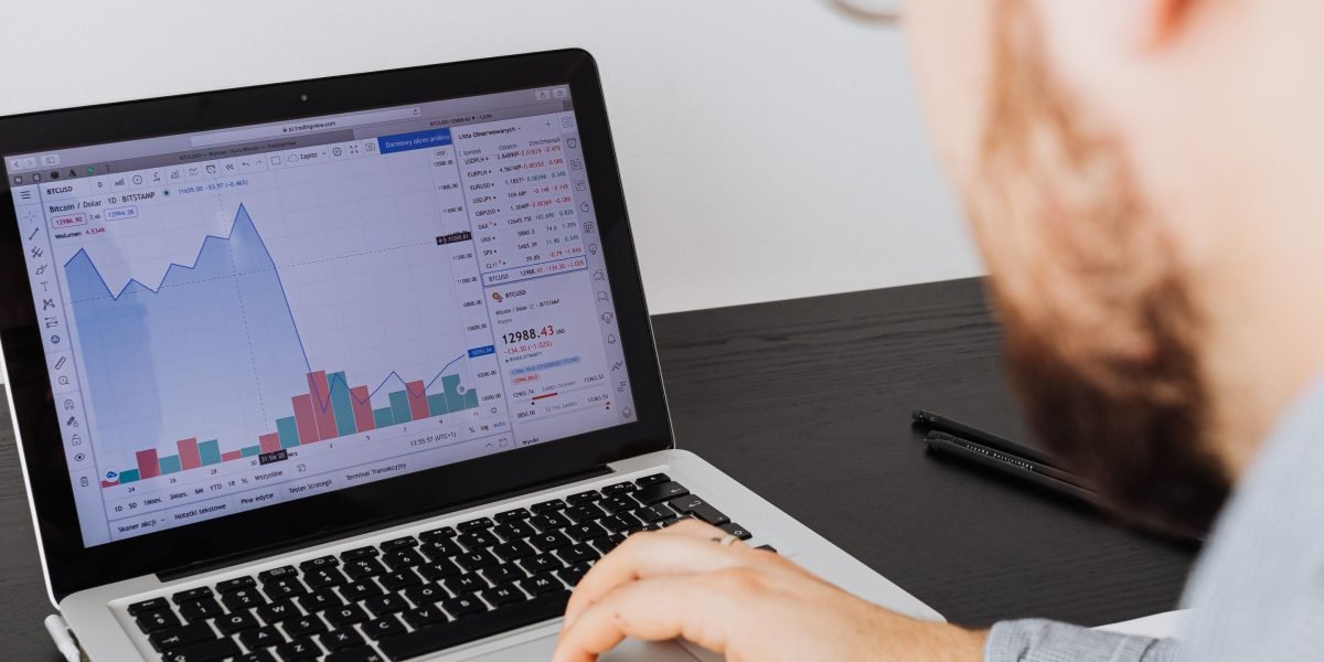 An investor reviewing financial data on a tablet, symbolizing the assessment of investment potential in real estate.
