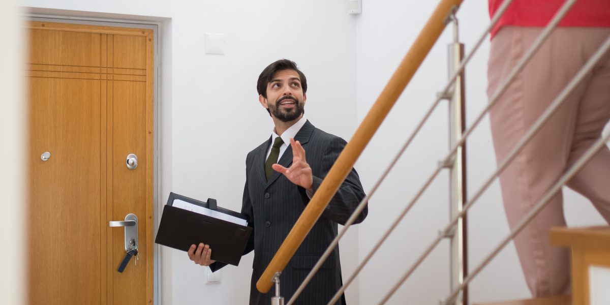 A real estate agent showing a potential buyer around a luxury property.