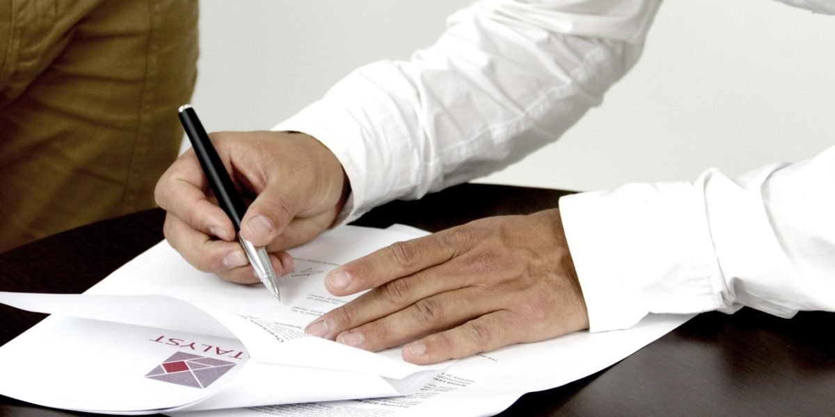 An individual signs a Memorandum of Understanding (MoU) for a property purchase.